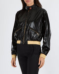 Chanel Cruise 2023 Black Shiny Bomber Jacket with Gold Trims and Zippers with Red and Gold CC Logo Button Size FR 38 (UK 10)