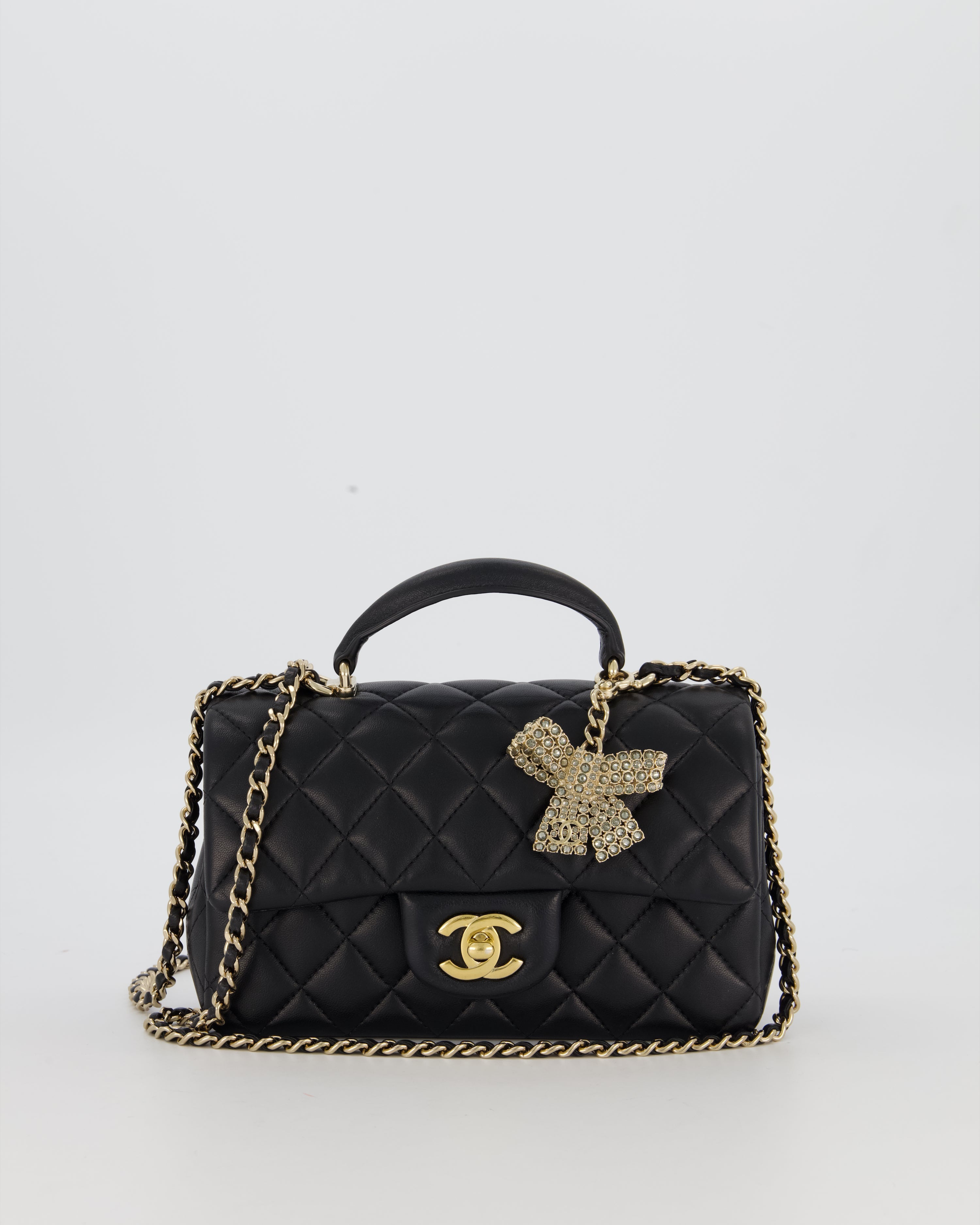 Chanel Black Mini Rectangular Top Handle Flap Bag in Lambskin Leather with Champagne Hardware and Strass Removable Bow Charm