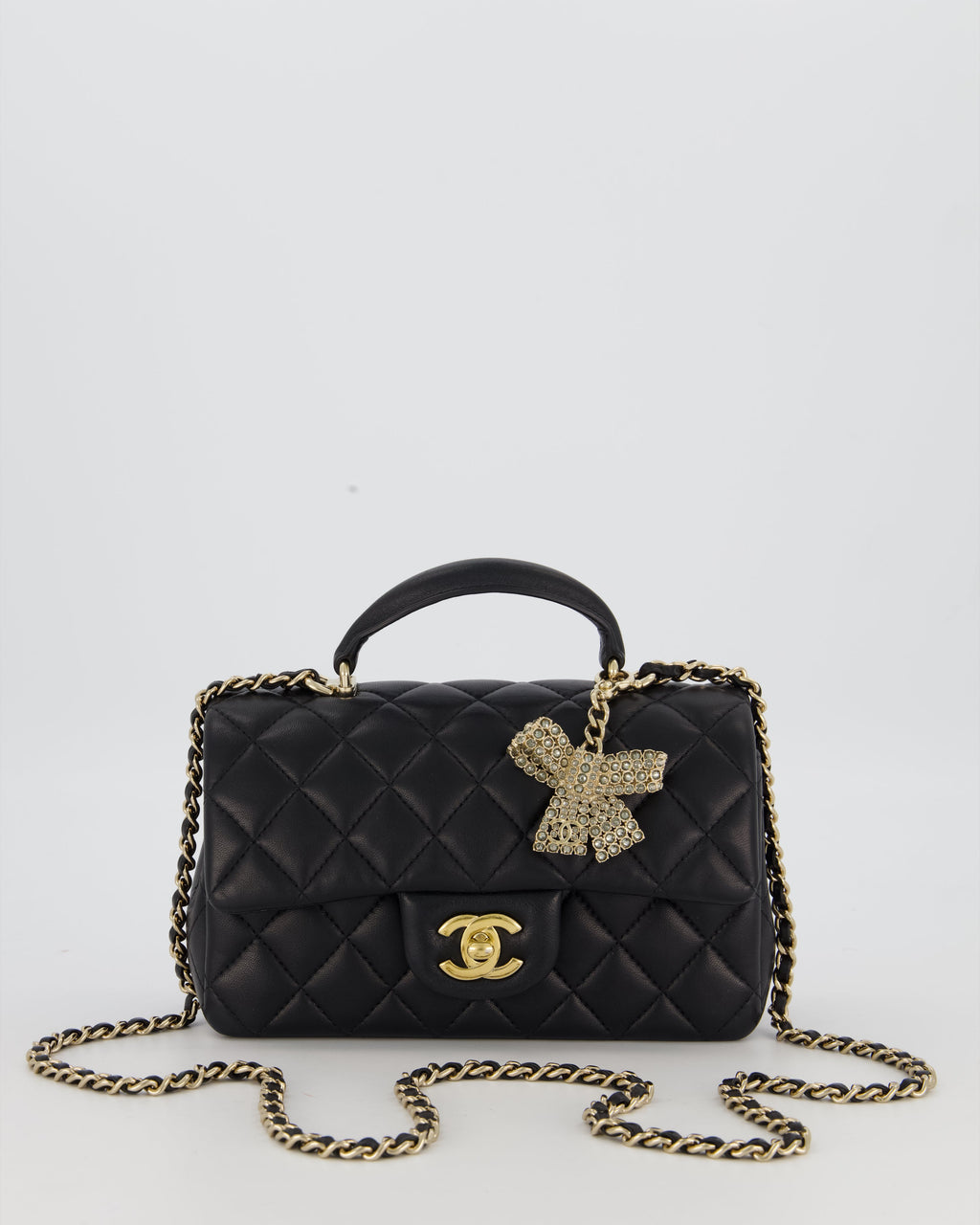 Chanel Black Mini Rectangular Top Handle Flap Bag in Lambskin Leather with Champagne Hardware and Strass Removable Bow Charm