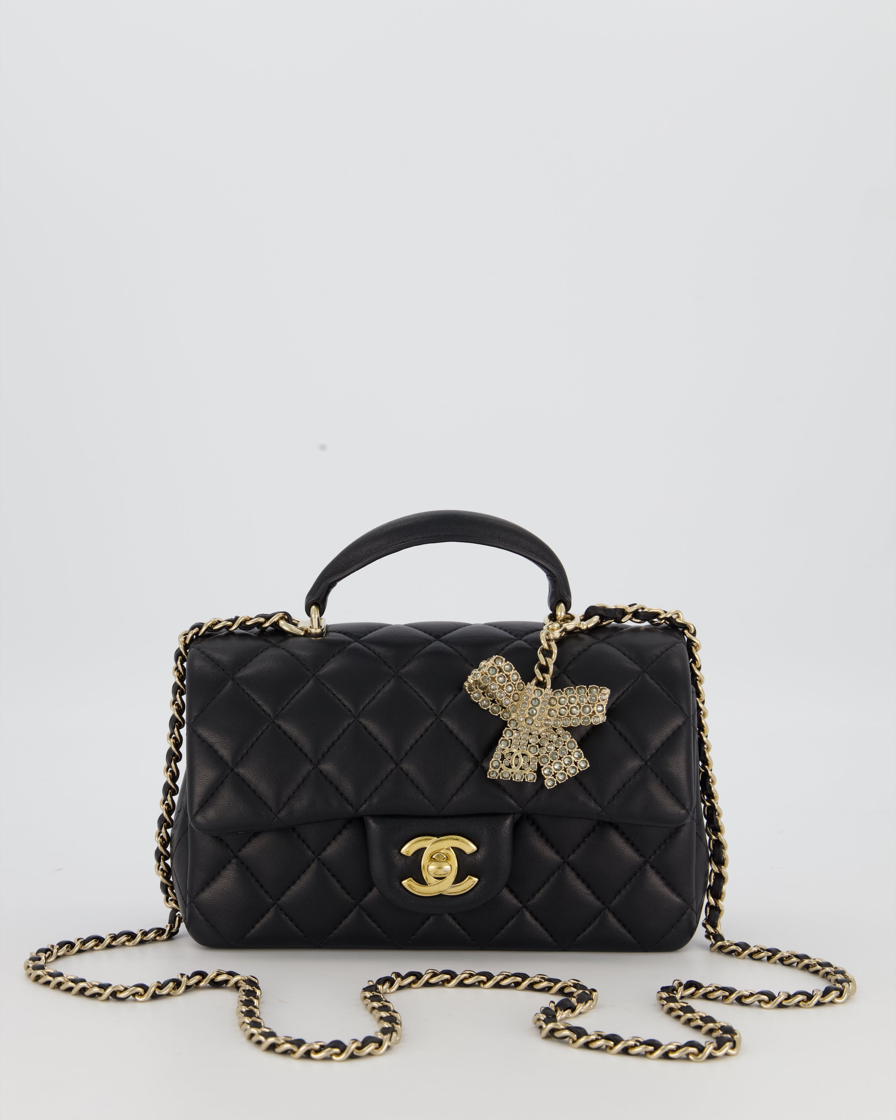 Chanel Black Mini Rectangular Top Handle Flap Bag in Lambskin Leather with Champagne Hardware and Strass Removable Bow Charm