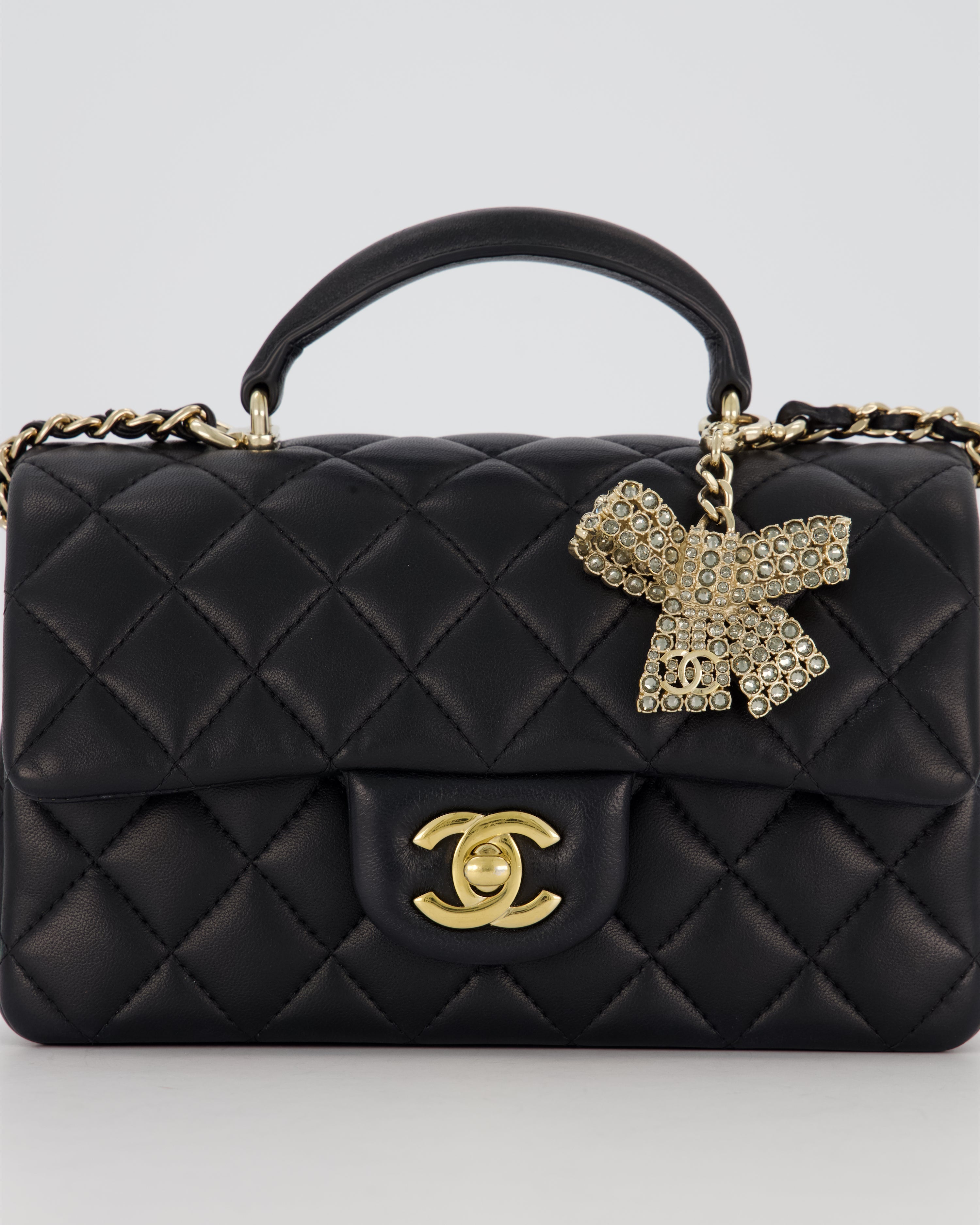 Chanel Black Mini Rectangular Top Handle Flap Bag in Lambskin Leather with Champagne Hardware and Strass Removable Bow Charm