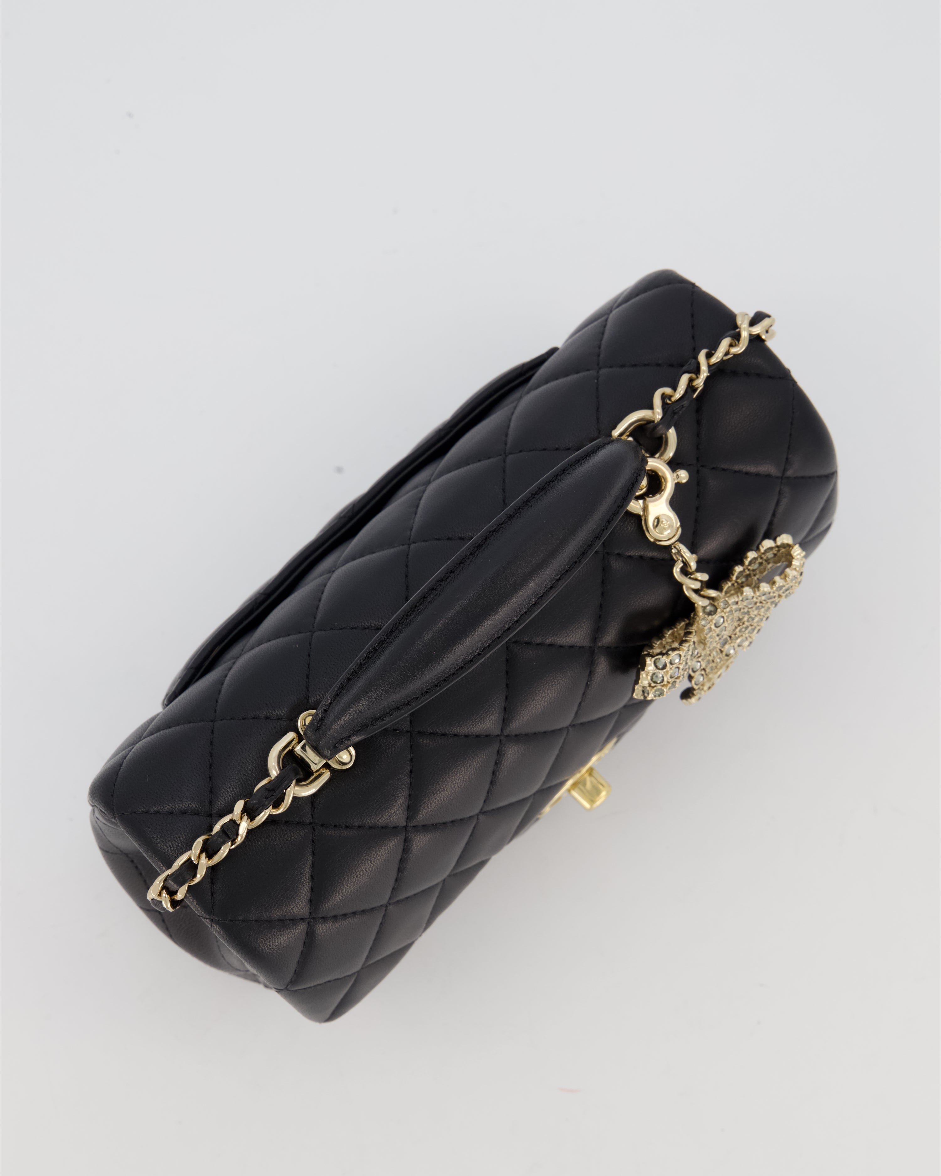 Chanel Black Mini Rectangular Top Handle Flap Bag in Lambskin Leather with Champagne Hardware and Strass Removable Bow Charm