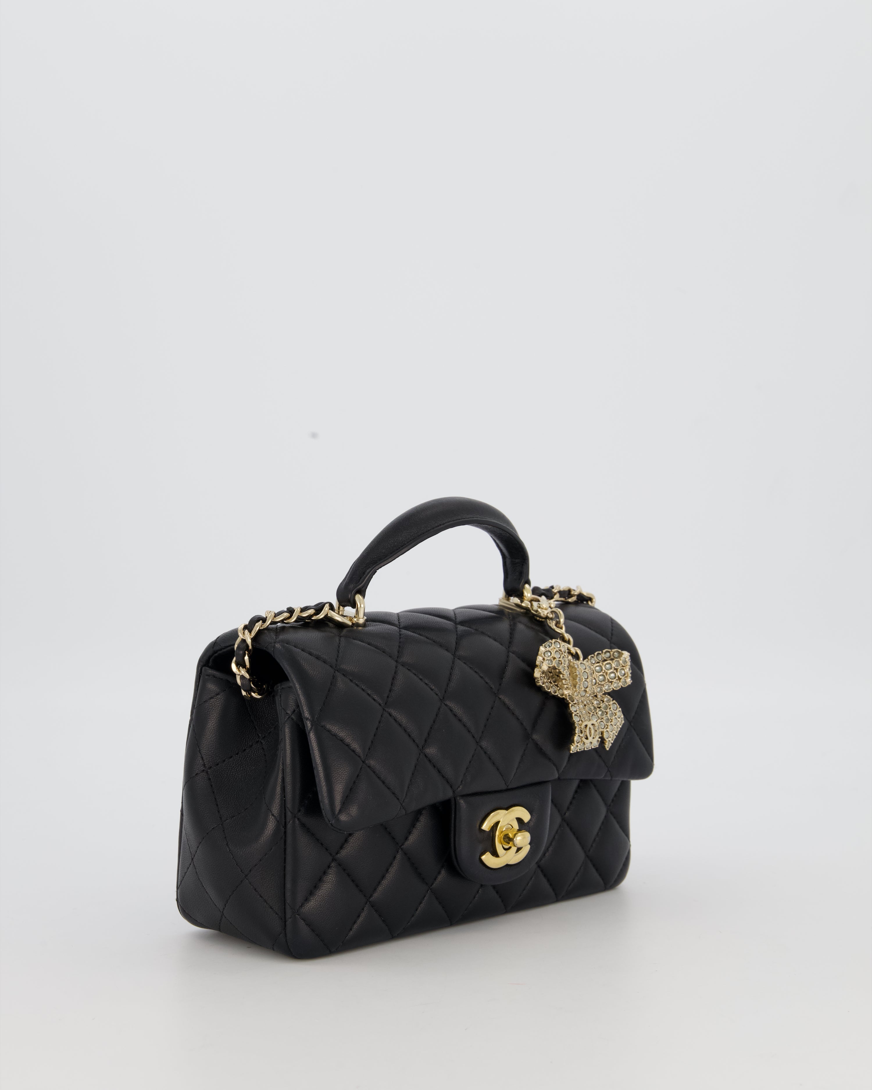 Chanel Black Mini Rectangular Top Handle Flap Bag in Lambskin Leather with Champagne Hardware and Strass Removable Bow Charm