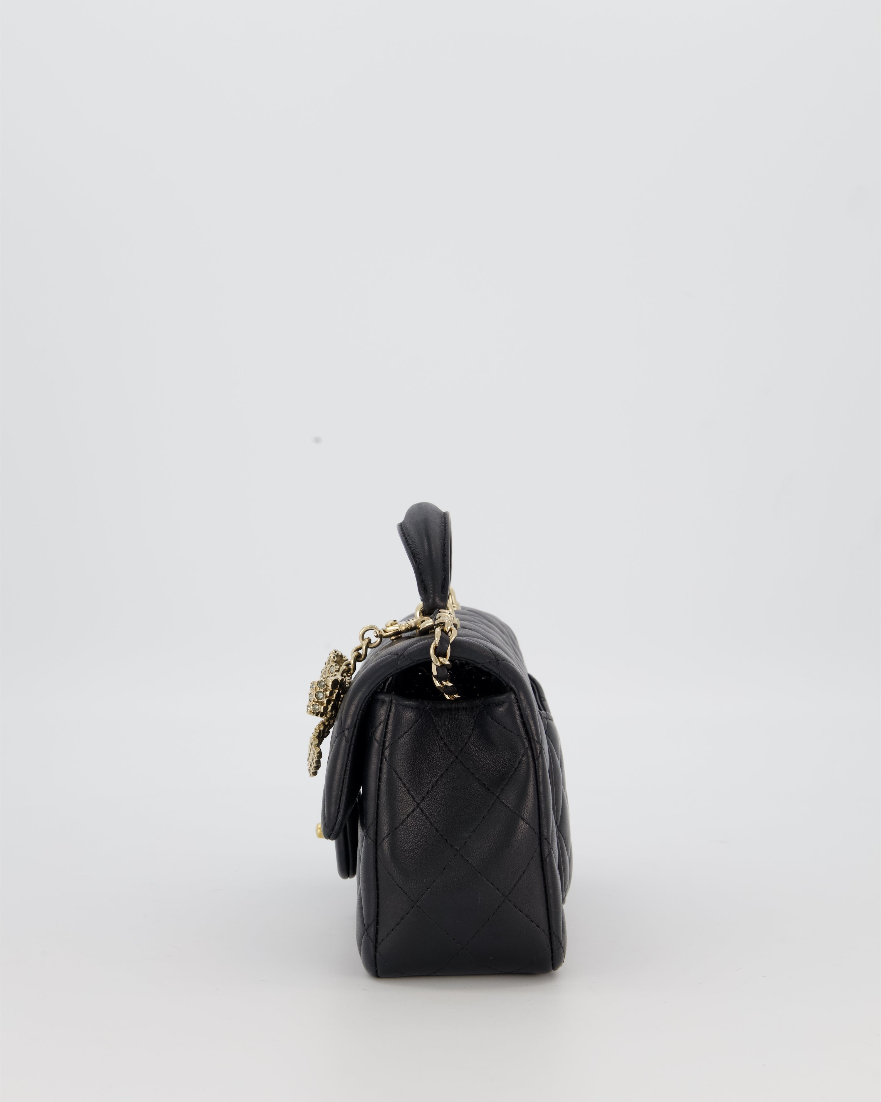 Chanel Black Mini Rectangular Top Handle Flap Bag in Lambskin Leather with Champagne Hardware and Strass Removable Bow Charm