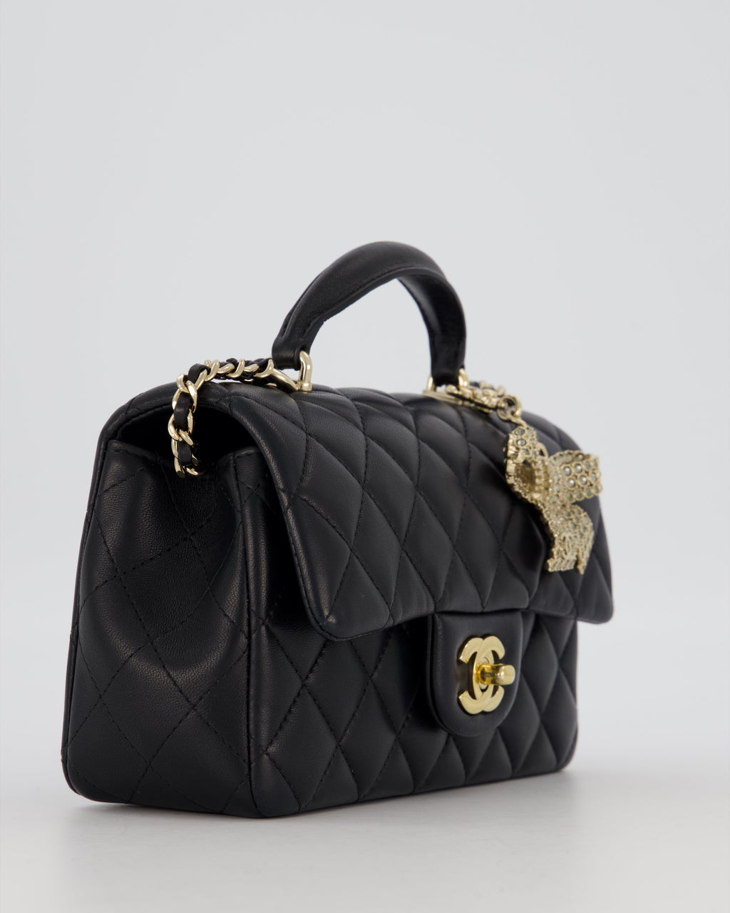 Chanel Black Mini Rectangular Top Handle Flap Bag in Lambskin Leather with Champagne Hardware and Strass Removable Bow Charm