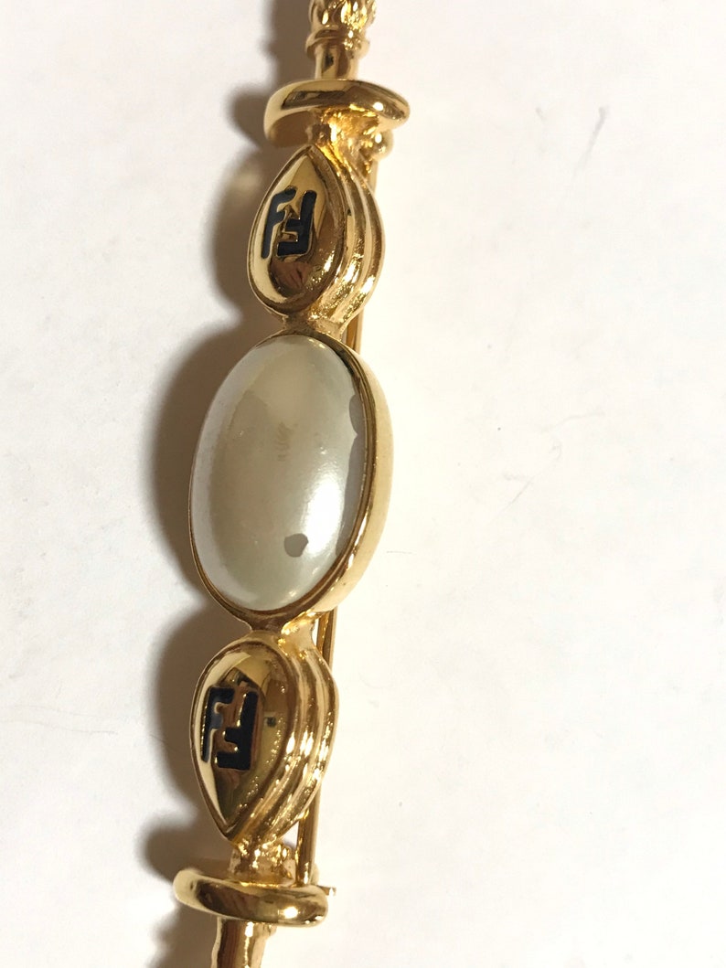 FENDI Vintage gold tone hat pin with white oval faux pearl and FF mark