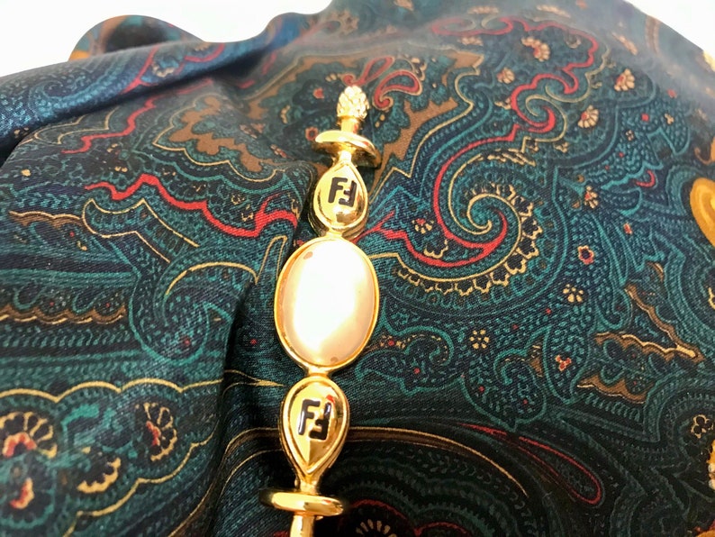 FENDI Vintage gold tone hat pin with white oval faux pearl and FF mark